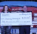 Chief Ryan Simmons and fire fighter Brianne Beissmann accepting donation check to Platteville Fire Facility Project