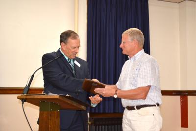 League of Wisconsin Municipalities Executive Director Jerry Deschane presenting the award to Senator Howard Marklein
