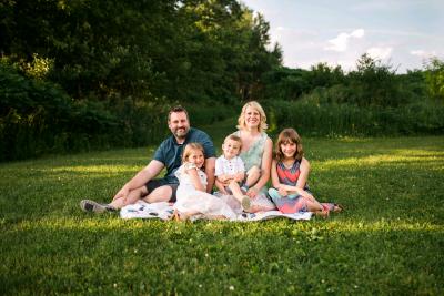 caption: Newly appointed Platteville City Manager Adam Ruechel with his wife, Jeni, and children, Ava,  Gabe and Chloe.