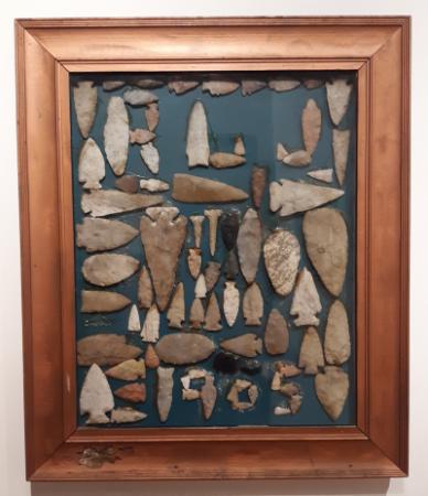 Photo of Rollo Jamison’s collage of Native American lithic tools depicting his initials “RLJ” 