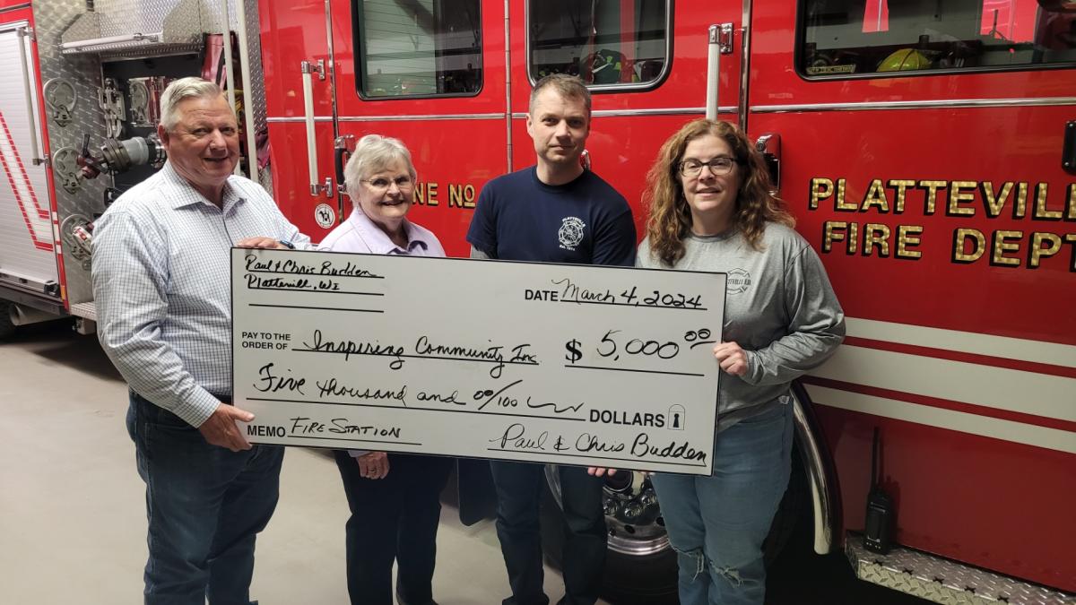 From left, Paul Budden, Chris Budden, and volunteer firefighters John Fick and Melissa Lovell