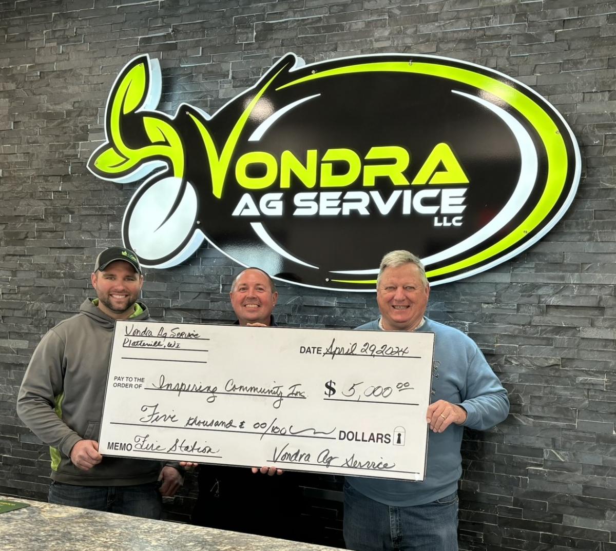 From left, Brady Vondra, Fire Chief Simmons, Paul Budden